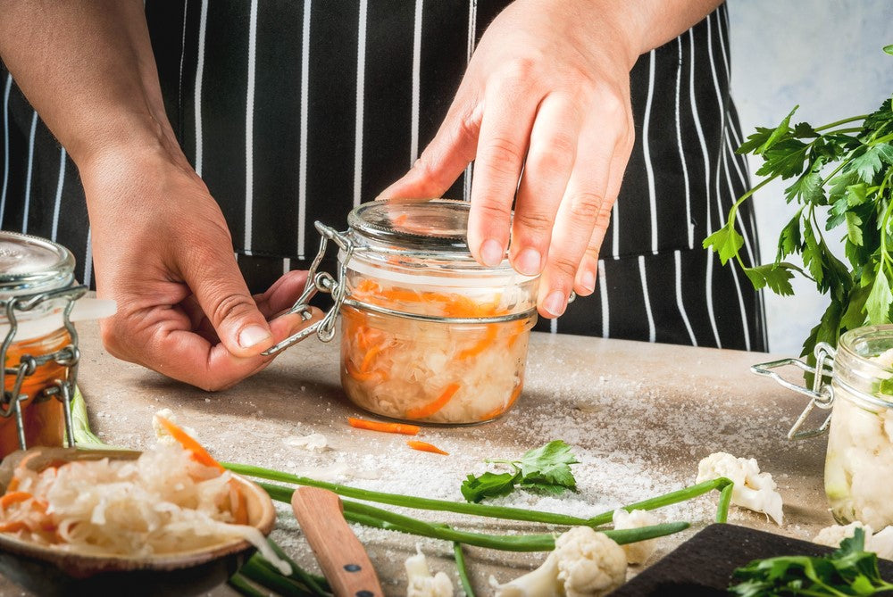 man preparing some dish from vegetables