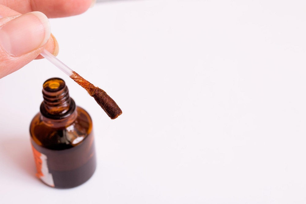 women hand holding liquid iodine
