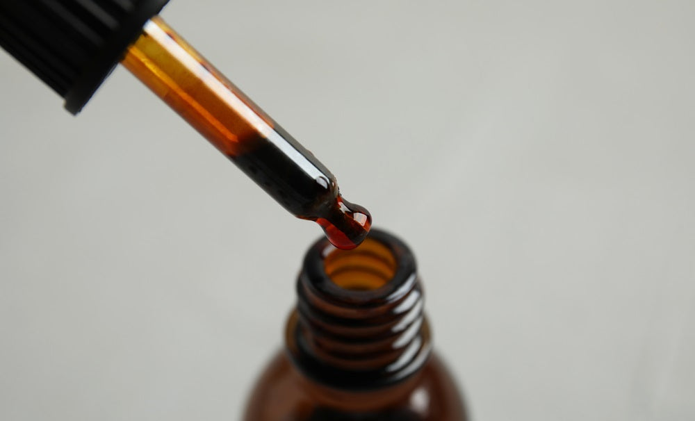 medical iodine from pipette into glass bottle